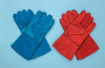 Work gloves on a blue background. Top view