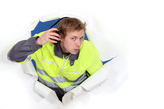 Man Wearing Reflective Jacket And Hearing Protection