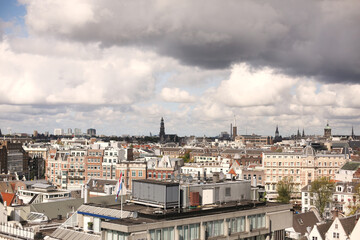 Obraz premium Amsterdam historic and modern panorama with historical buildings and landmarks on a sunny day. Birds eye/aerial view.Dutch architecture. Traveling in Netherlands and Europe.Copy space for information.