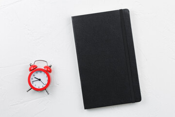 Black leather notebook with red alarm