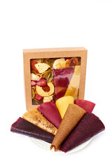 Dried fruits and fruit pastille in craft paper box with transparent lid