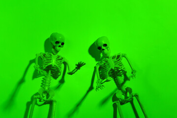 Scary skeletons in green neon light