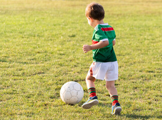 Young boy shooting soccer ball