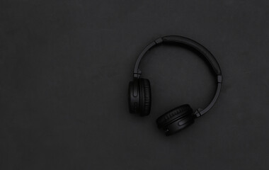Wireless stereo headphones on a black background. Top view