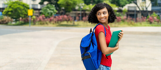 Pretty hispanic female college student with backpack