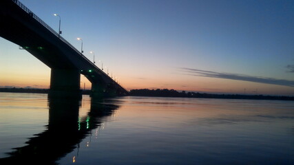 Sunset river bridge sky clouds. RIver bridge sunset scene. Sunset river brisge landscape