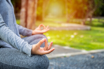 Young yoga woman meditation on the ocean beach at amazing sunset. Woman Yoga - relax in nature.
