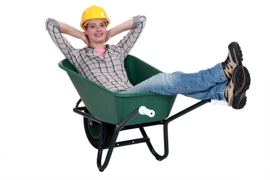 Woman Laborer Resting In A Wheelbarrow