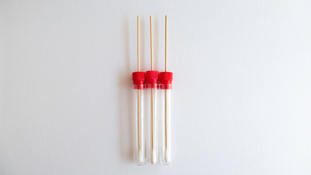 Arranged sample swabs tubes on white background. Copy space for text.
