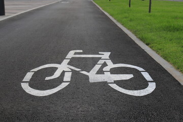 White drawn bike sign on the asphalt. Separate cycle path for cyclists, environmentally friendly urban transport for Sport . Dnepropetrovsk, Dnipro city, Ukraine