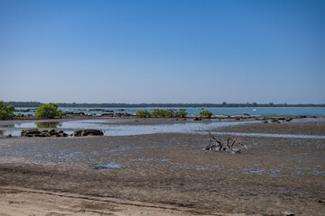 Coastline of a sand beach during low tide at Ngwesaung, Irrawaddy, Myanmar