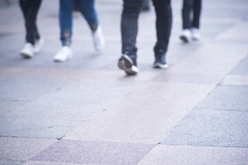 People walking sidewalk pavement