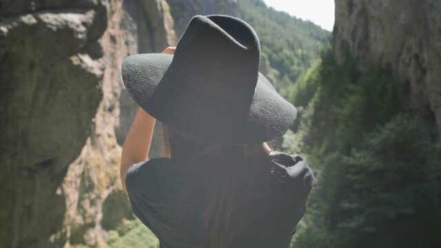 Aback view of stylish women making selfie in nature 