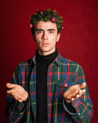 attractive man in a plaid shirt on a red background hair like a christmas tree christmas mood copyspace