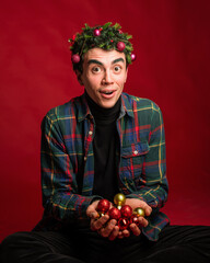 attractive man in a plaid shirt on a red background hair like a christmas tree christmas mood copyspace
