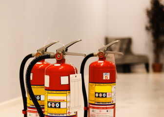 Red tank of fire extinguisher.