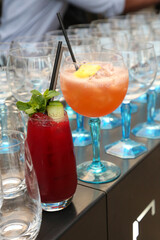 Red and Orange cocktails on a bar for an event.