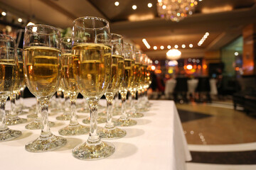 Champagne welcome drinks set up on a white cloth for an event.