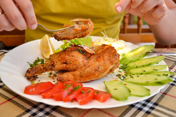 Eating delicious grilled chicken on bbq served with fresh seasonal vegetables