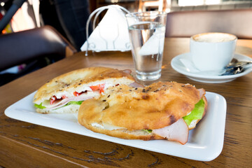 Delicious fast food breakfast in Serbia - ham, lettuce, onion and cheese in the traditional bun, somun bread