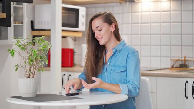 Young woman diabetic checks and measures blood glucose level using glucose meter. Treatment and controlling sugar diabetes, healthcare