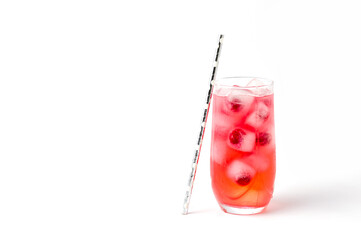 A glass of cherry soda with ice on a white background.