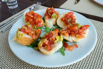 Bruschetta is an antipasto (starter dish) from Italy consisting of grilled bread rubbed with garlic and topped with olive oil ,salt, tomato, garlic basil and herbs
