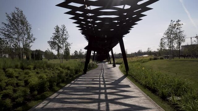Walking under the unusual wooden construction of Tyufeleva roshcha park. Action. Tuffel grove park, modern public place located in Moscow, Russia.