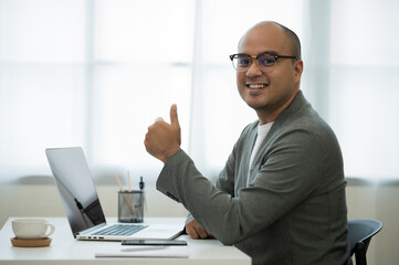 A middle-aged man around the age of 35. Working at home Work through the laptop by meeting video...