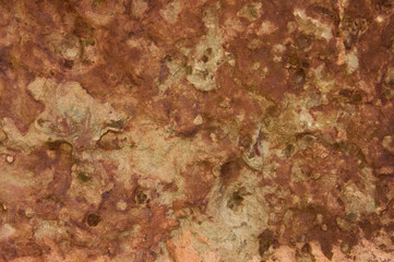 Texture of decorative plastered wall with brown spots close up