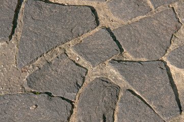 Obraz premium Texture of gray vintage natural urban paving stone close up