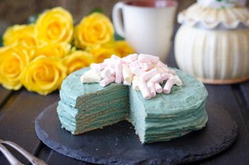 Fototapeta na wymiar Pancake cake with sour cream and spirulina