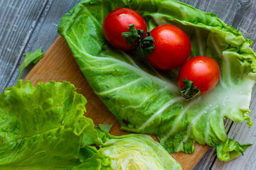 cherry tomatoes with cabbage and salad on a cutting board