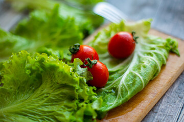 cherry tomatoes with cabbage and salad on a cutting board