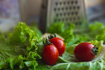 cherry tomatoes with cabbage and salad on a cutting board
