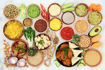 Large vegan health food collection for vitality & fitness high in protein, omega 3, antioxidants, anthocyanins, smart carbs, vitamins, minerals & lycopene. Foods for ethical eating on marble.