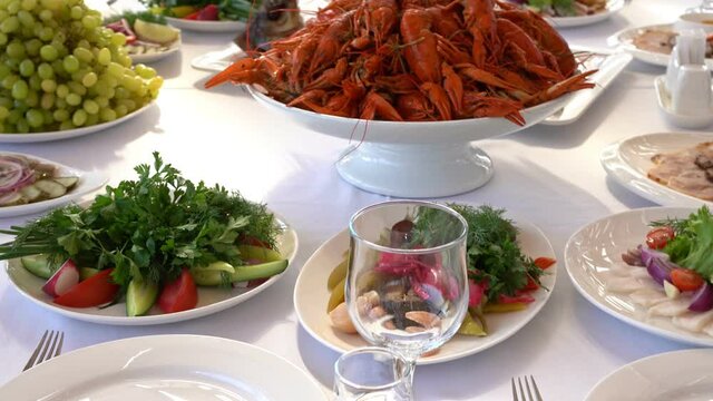 salted and pickled vegetables, snacks, bream and crayfish on holiday table.