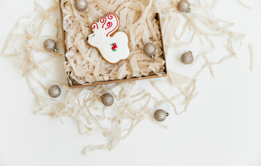 new year and christmas gingerbread cookies and christmas balls. deer shaped. top view. white background. minimalist style.