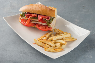 Sandwich Serranito typical in Andalusia with ham, gren pepper and grilled pork loin