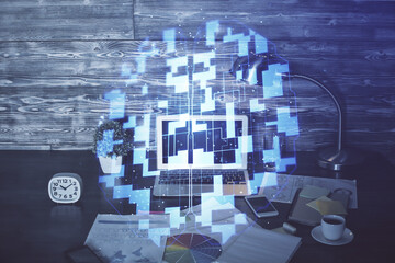 Double exposure of laptop computer and technology theme hologram. Concept of freelance work.