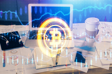 Double exposure of blockchain theme hologram and table with computer background. Concept of bitcoin crypto currency.