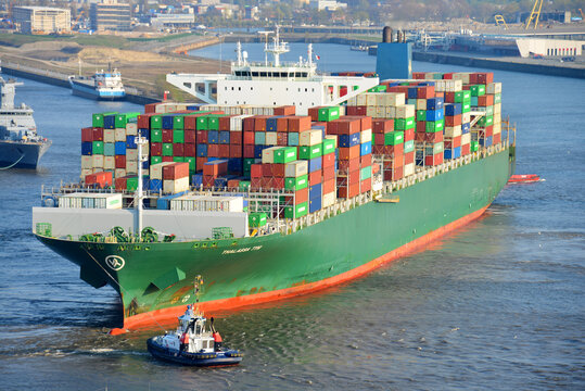 Hamburg / Germany - April 8, 2019: Container ship Thalassa Tyhi (Length 368.5 meters, 13808 TEU) is leaving Hamburg Harbour