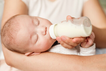baby eats milk from a bottle and sleep