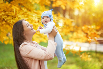 Naklejka premium portraits of mom and baby in autumn park