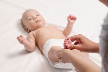 baby foot massage, close-up of hands and foot of baby