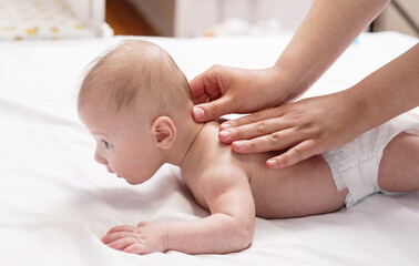 baby massage, close-up hands on baby back