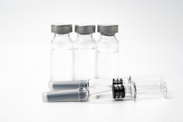 Vaccine concept with syringe and vial on a white background.