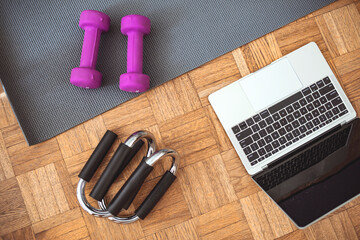 Set of workout inventory, using laptop computer. Body care, healthy lifestyle, distance exercising, sport, workout, technology, pilates concept.