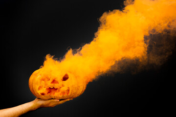 Spooky pumpkin With Orange Smoke over a black background