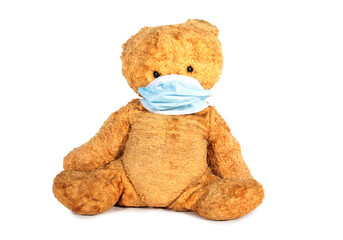Teddy bear in a medical mask. Isolated object on white background